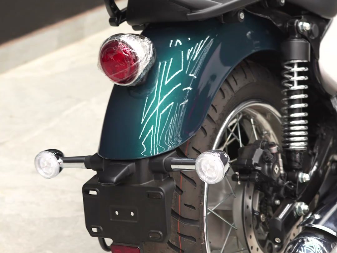 Hand-drawn teal pinstripe on a Jawa tank.