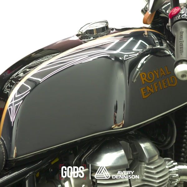 Gold pinstriping on a black Royal Enfield tank.